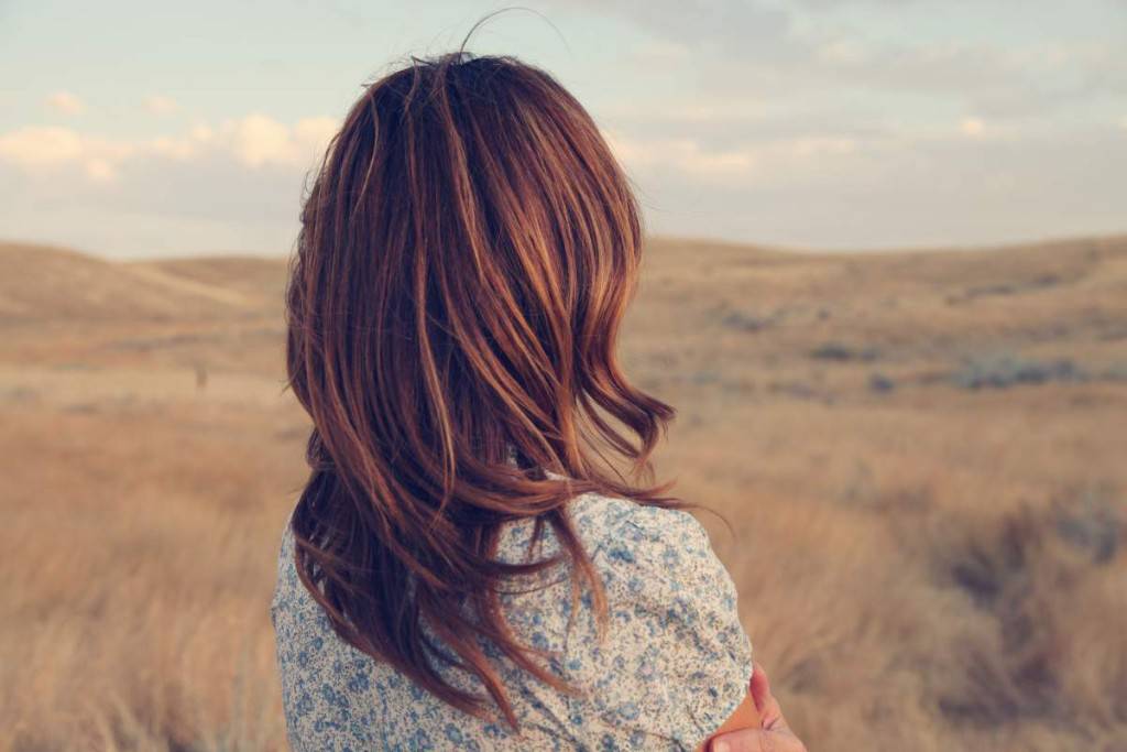 Woman overlooking grassy landscape