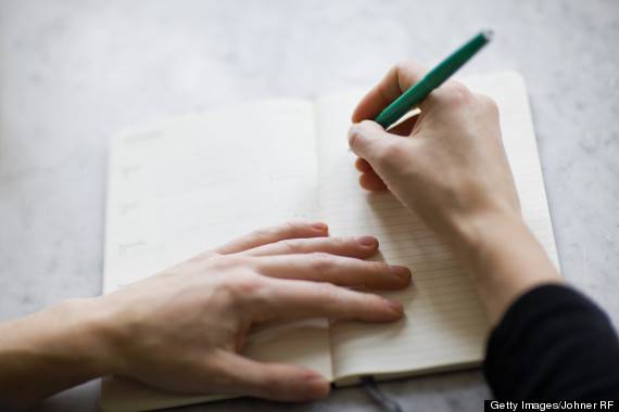 Woman writing on diary